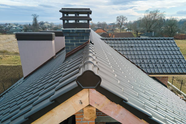 Closeup of house roof top covered with ceramic shingles. Tiled covering of building under construction.